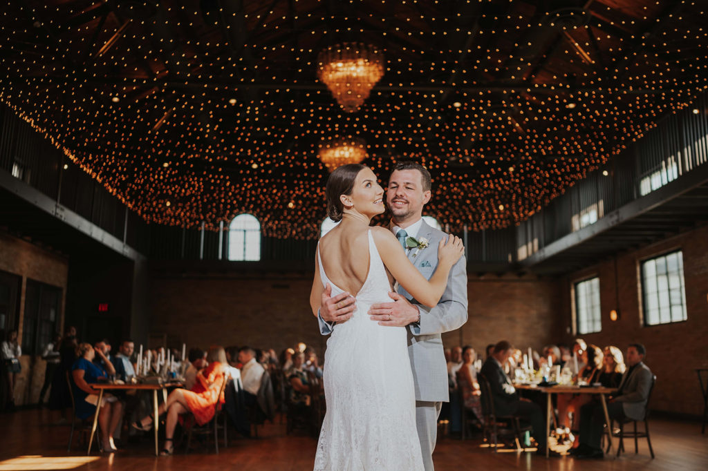 Bride and groom first dance under twinkly lights at the Common House in Chattanooga.