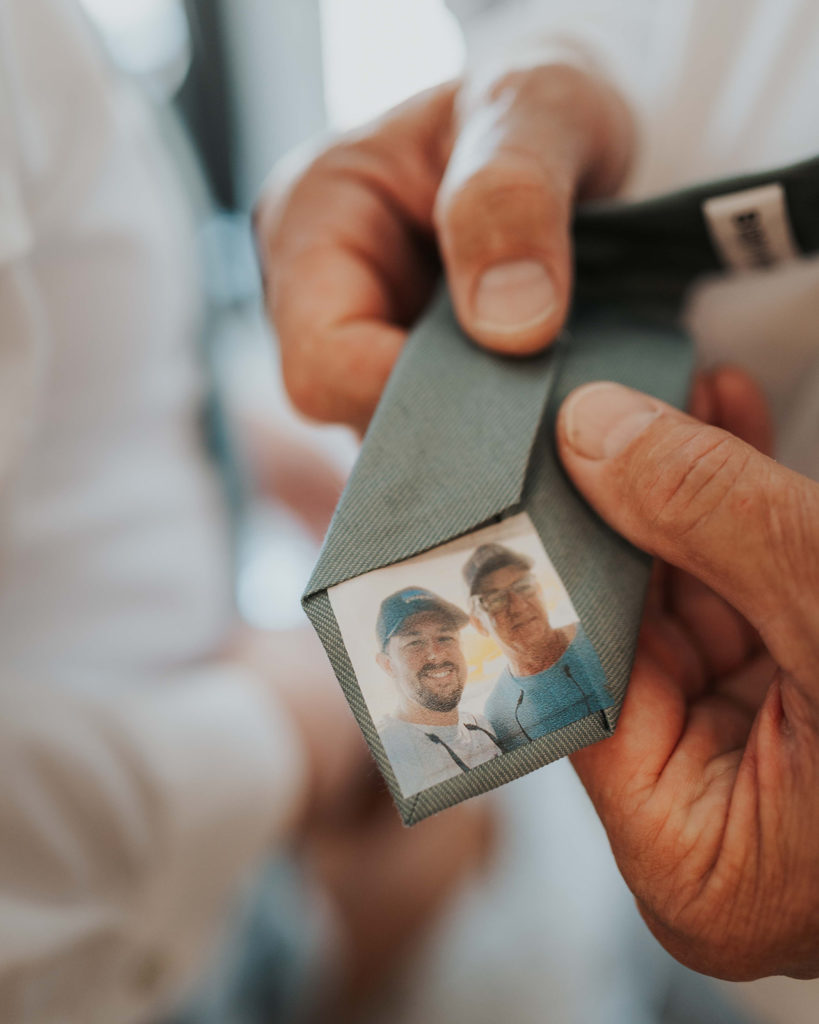 Custom wedding tie with a picture of the groom and his dad on the back.