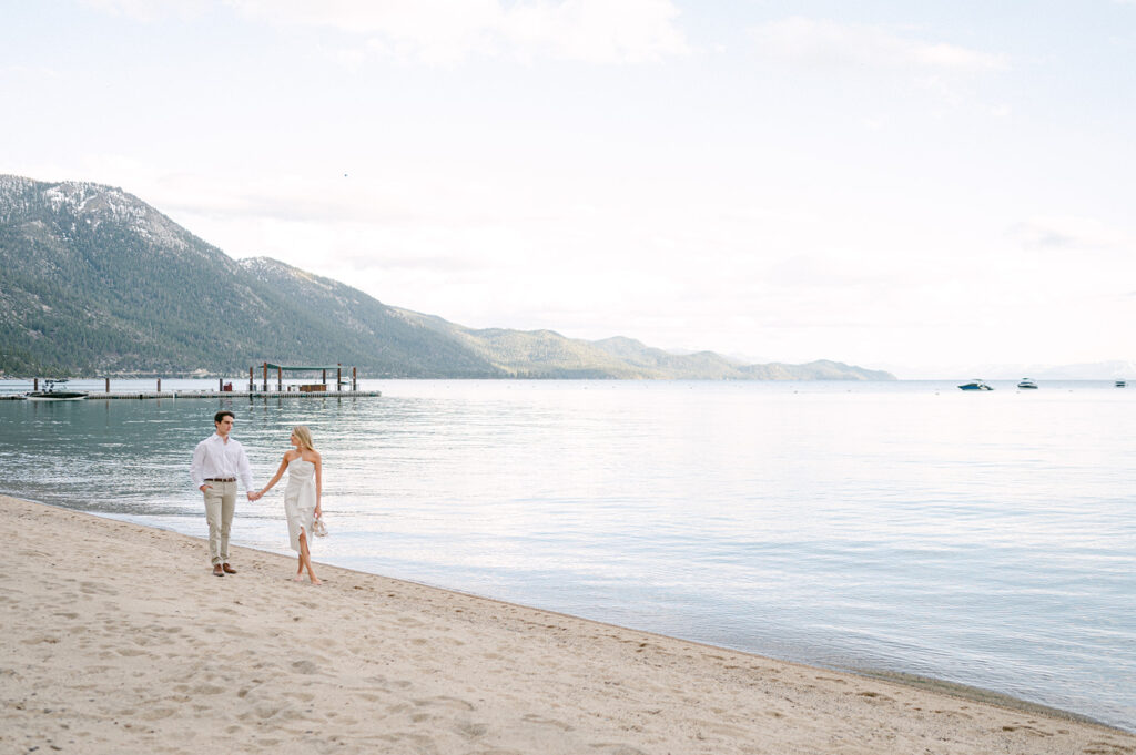 Couple walks on Lake Tahoe beach, an engagement photo location.