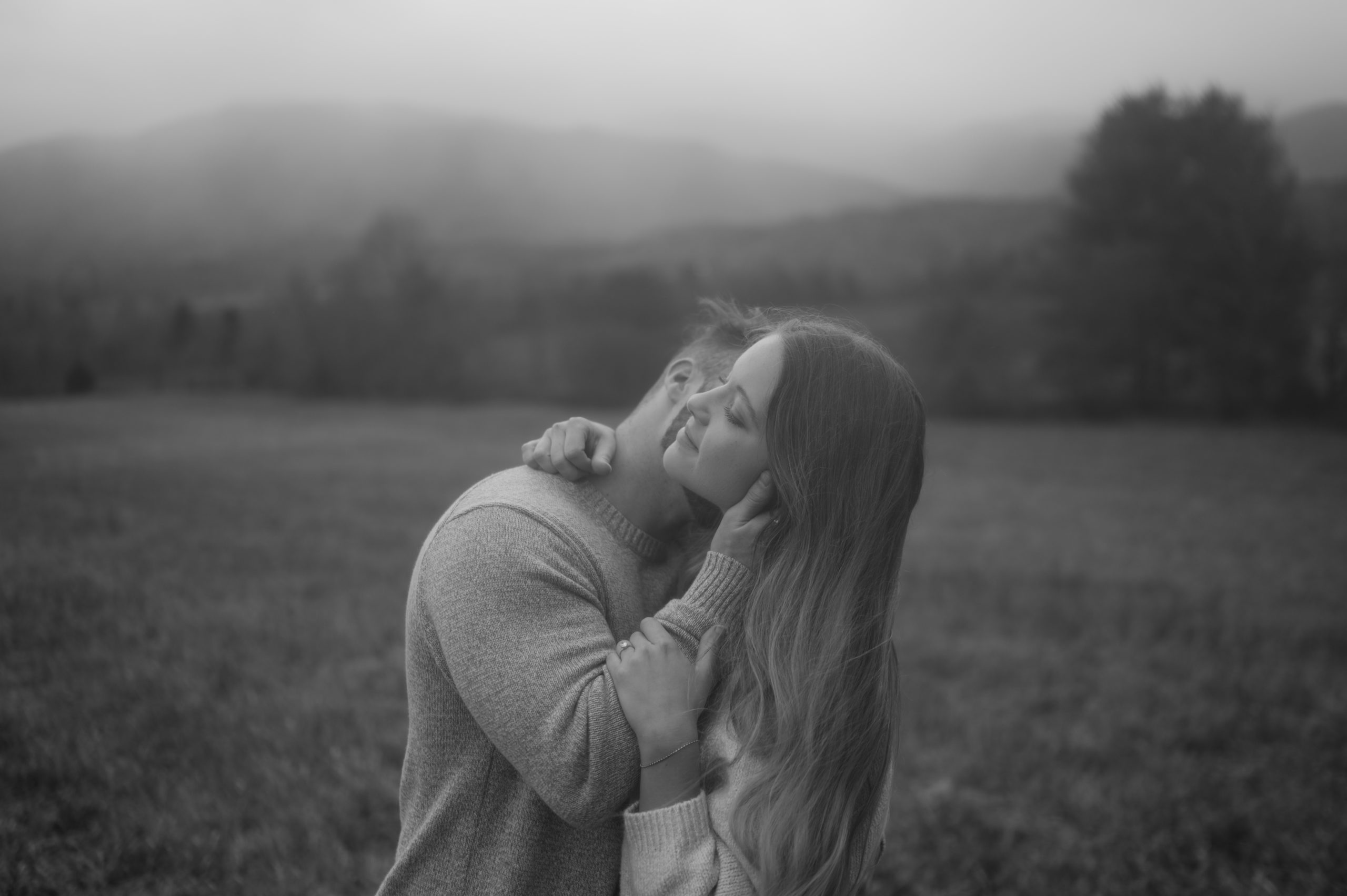Couple shares an embrace during their engagement photographs in the Smoky Mountains.