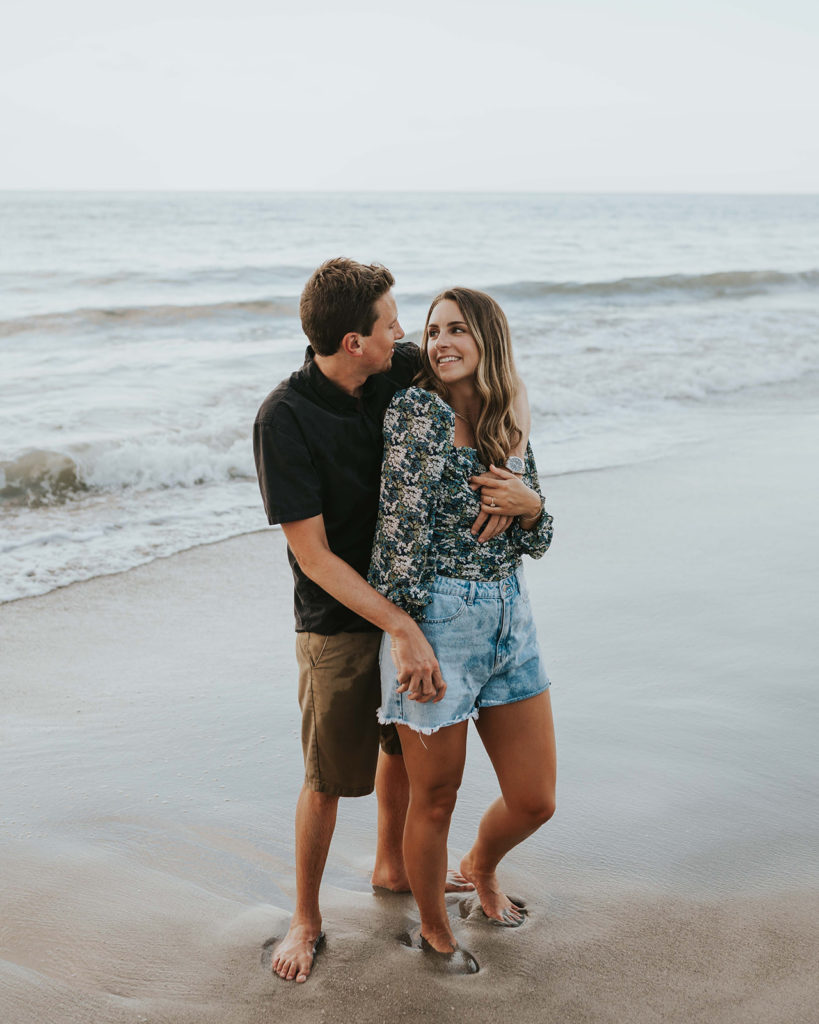 Man and woman hug each other on the beach