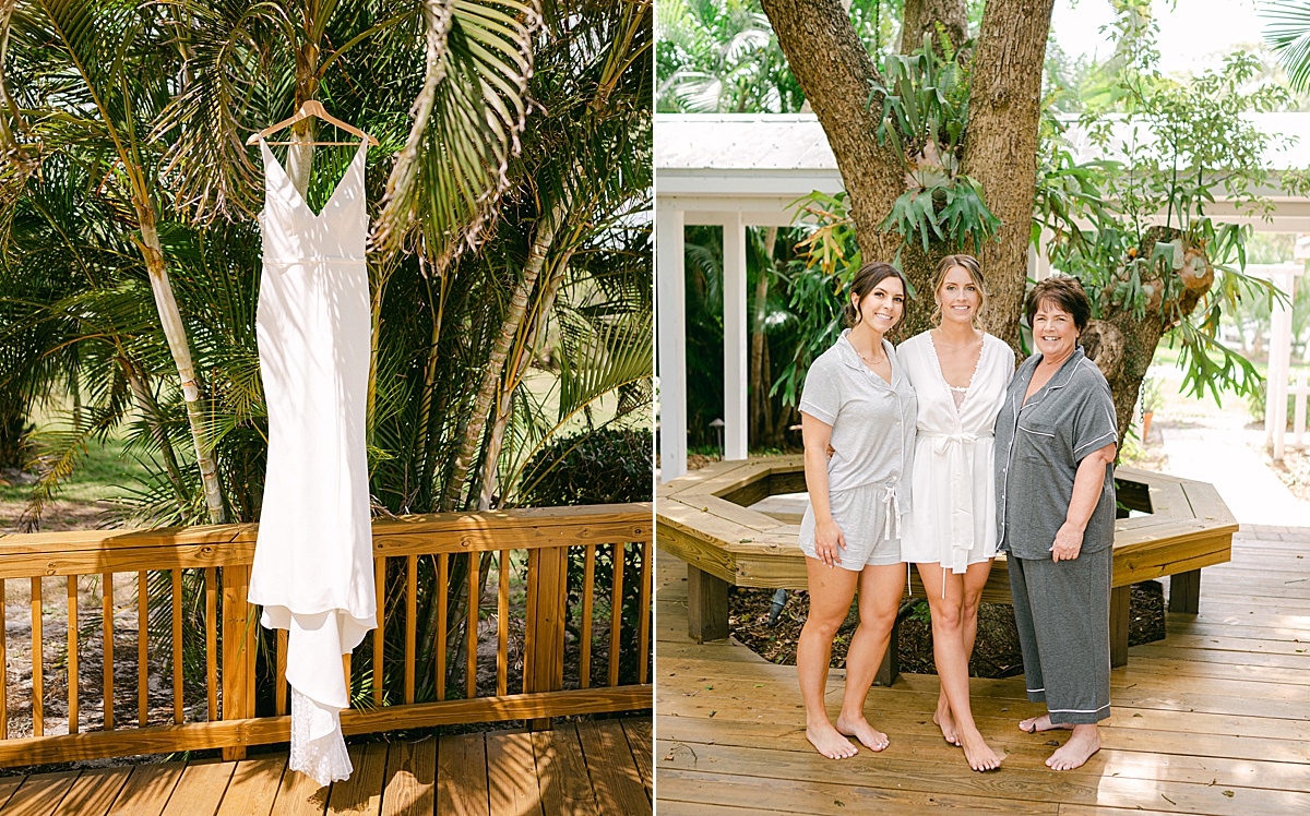 Tropical wedding dress hanging from a palm tree and bride standing with her mom and sister on the morning of her wedding.
