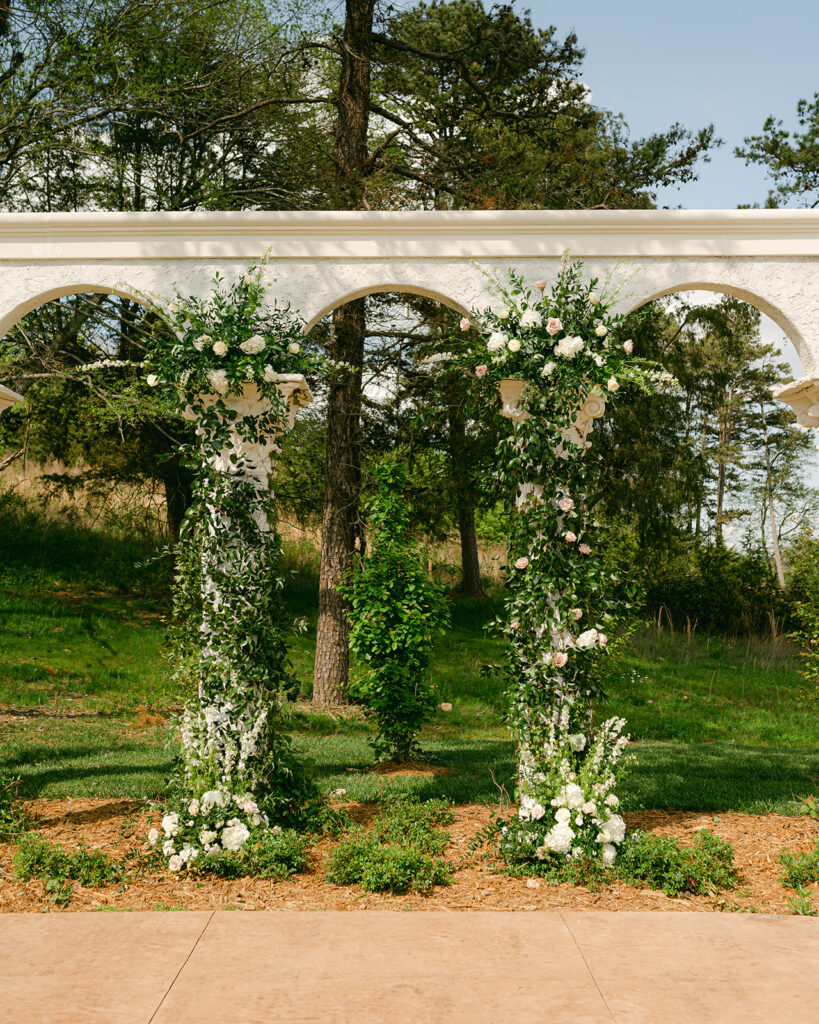 Wedding ceremony with large floral bouquets at Woodlands of Five Gables at Howe Farms. 
