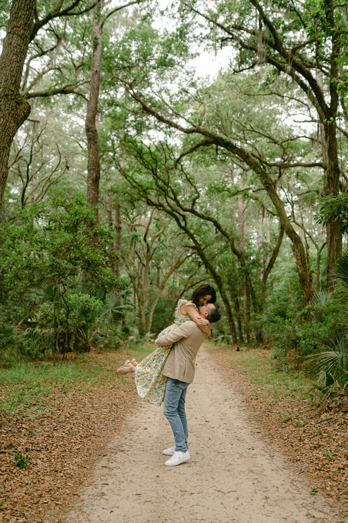 Greenery filled engagement photos in Charleston with oak trees and Spanish moss. 