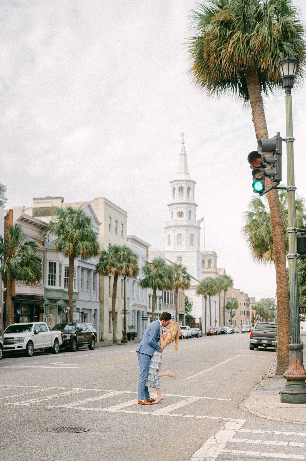 Husband and Wife share a kiss in the French Quarter of Charleston, South Carolina during their portrait session. Photographed by Sarah Woods Photography.