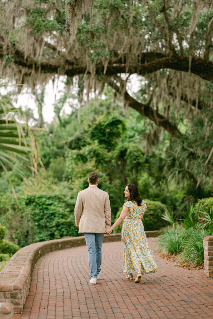 Charming couple walking on a brick path during their Palmetto Bluff photoshoot.