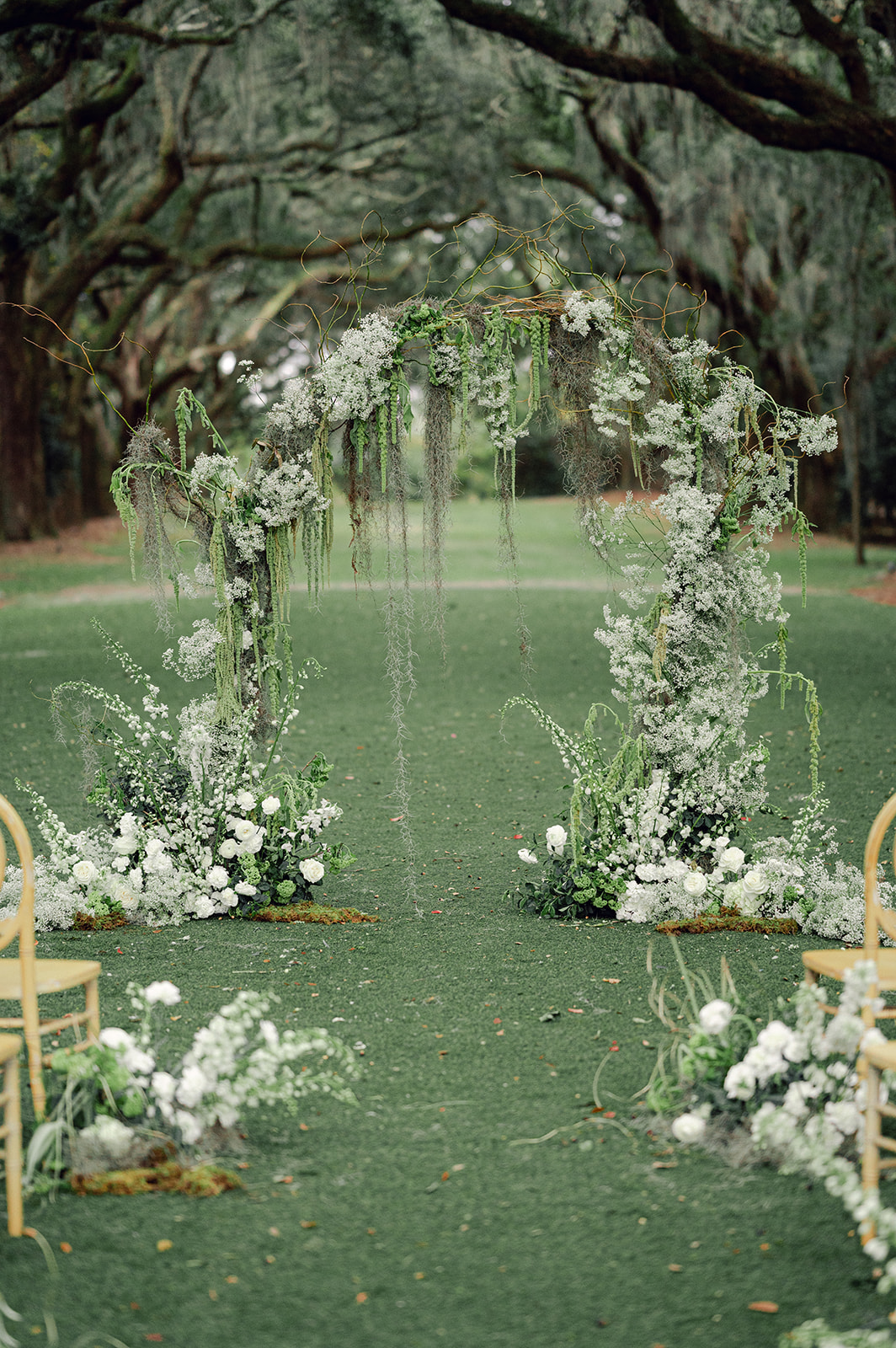 Romantic hanging moss freestanding floral arch at a Legare Waring House wedding ceremony. 