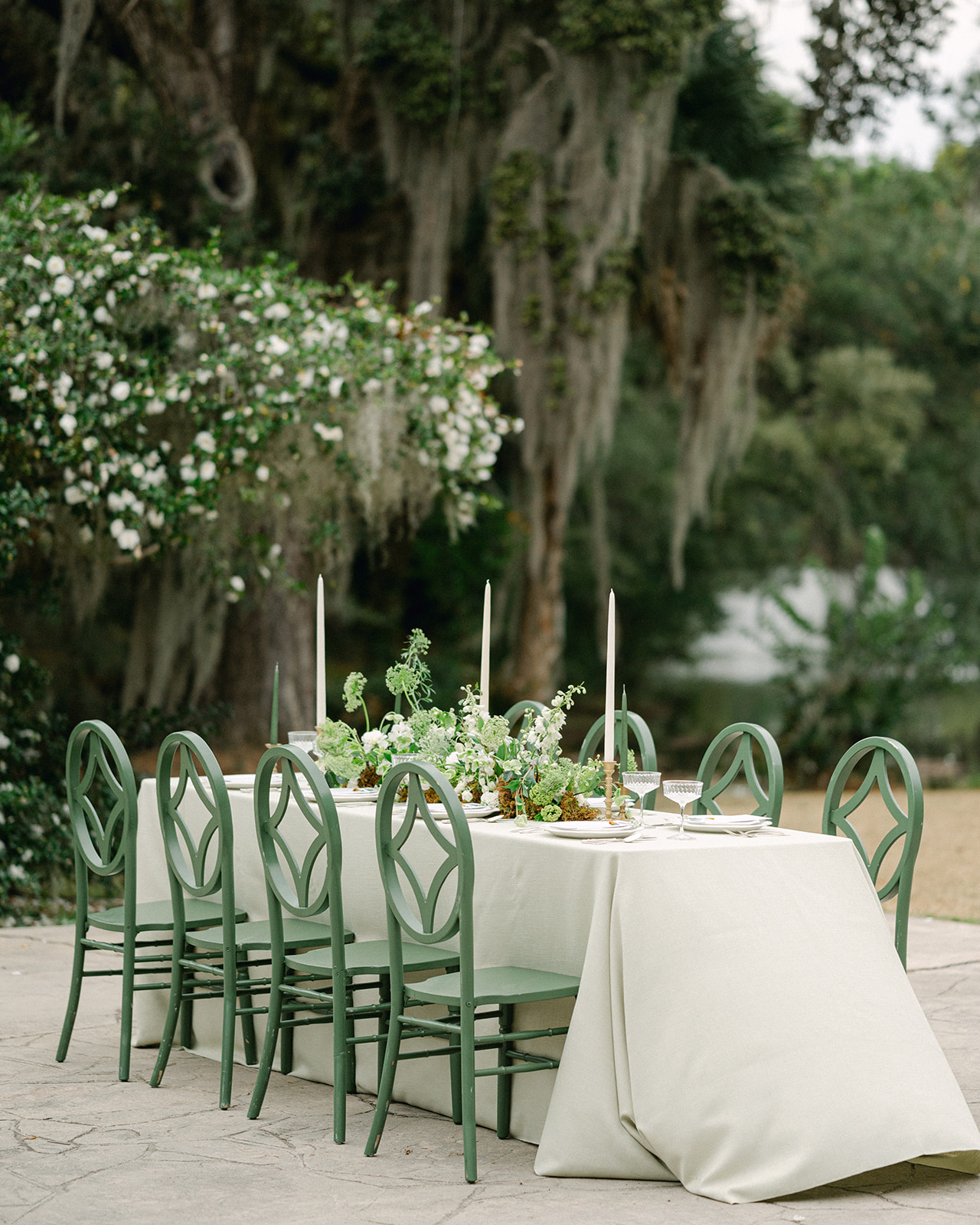 Neutral wedding tablescape with green chairs at Legare Waring House. 