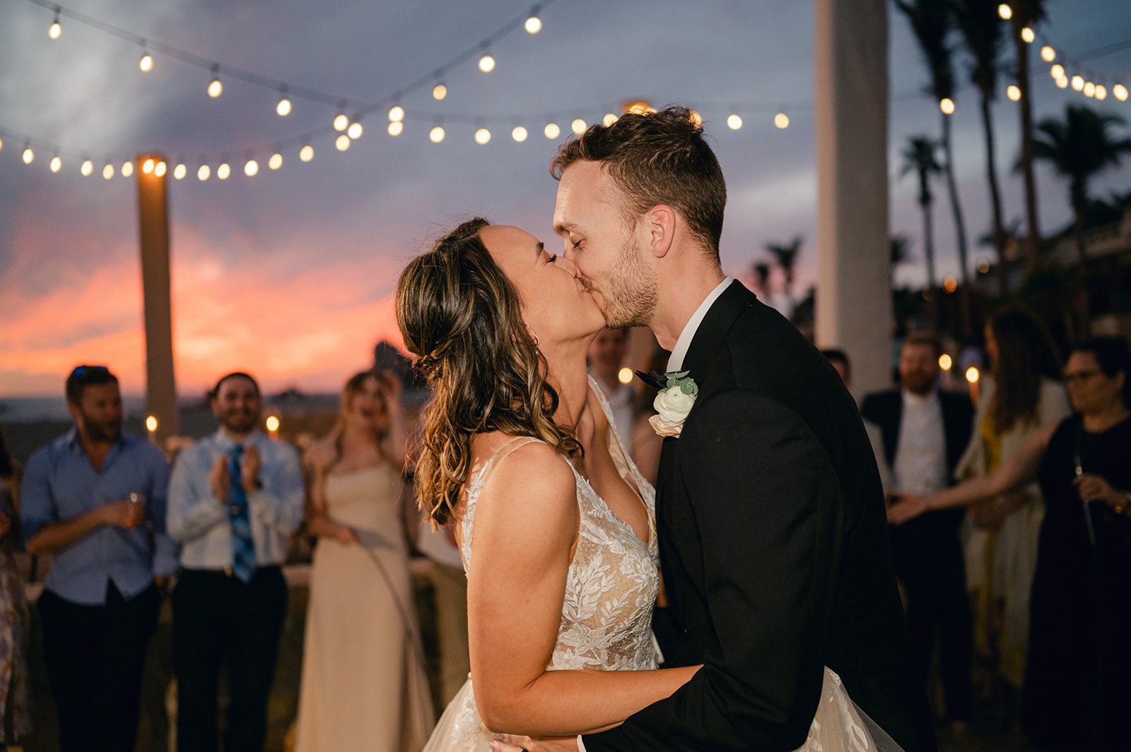 Bride and groom kissing during their first dance at their intimate wedding weekend in Cabo. 
