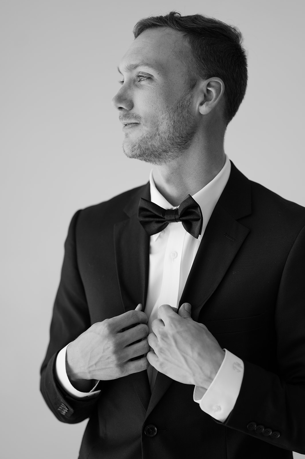 Black and white groom portrait wearing classic black attire. 