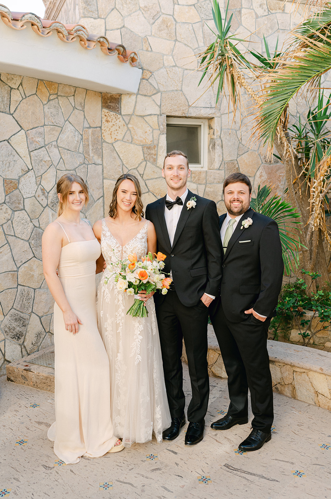 Bride and groom portrait with Maid of Honor and Best Man outside Villa Marcella in Cabo. 