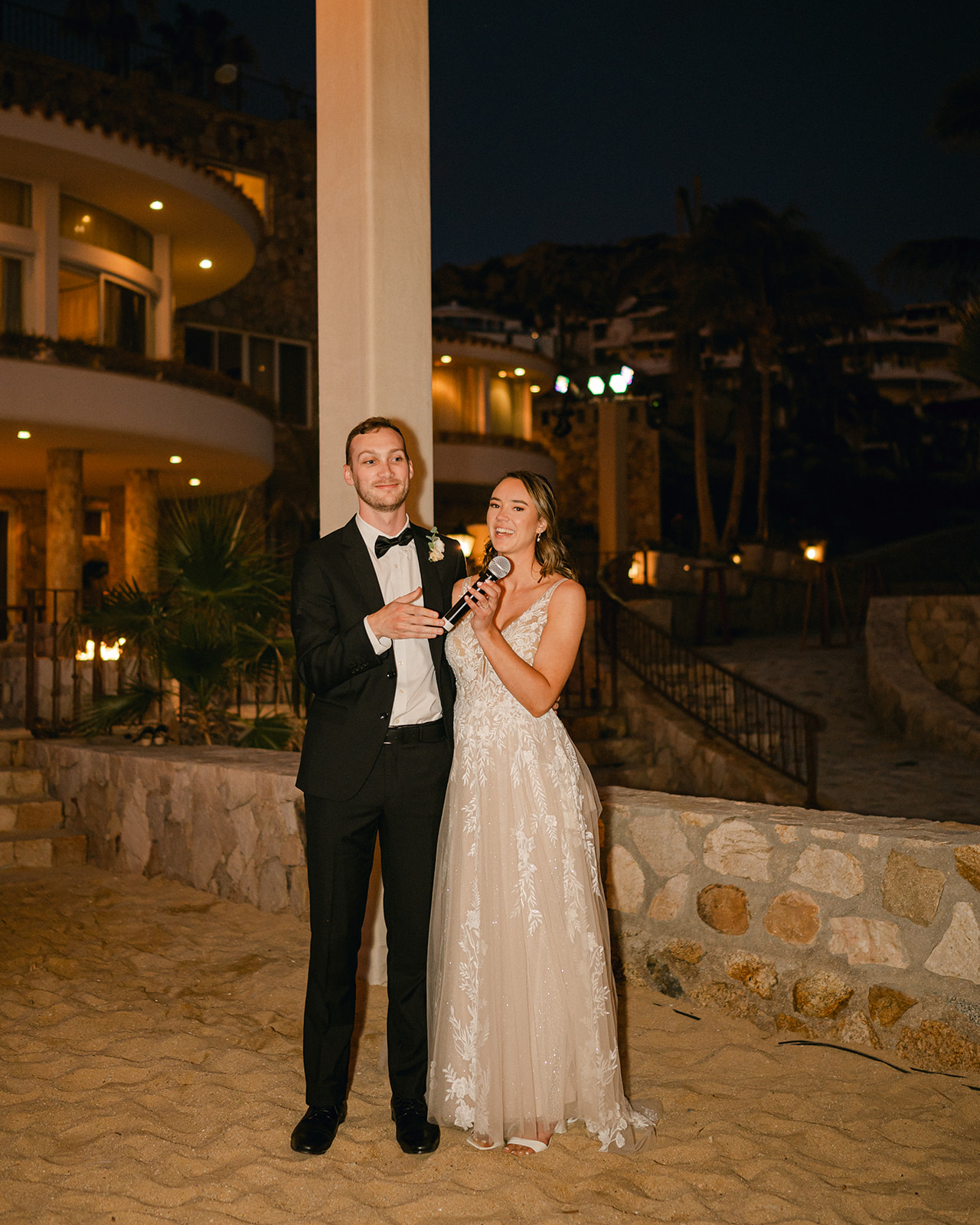 Bride and groom giving a speech at their destination wedding reception in Cabo. 