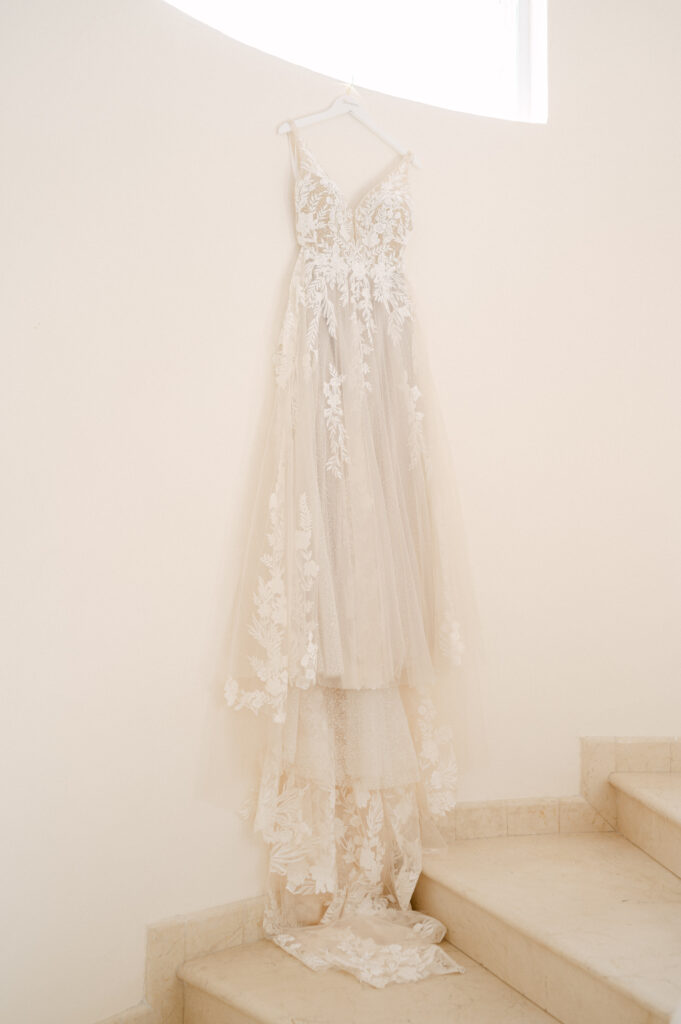 Wedding dress hanging from a window sill at Villa Marcella in Cabo. 