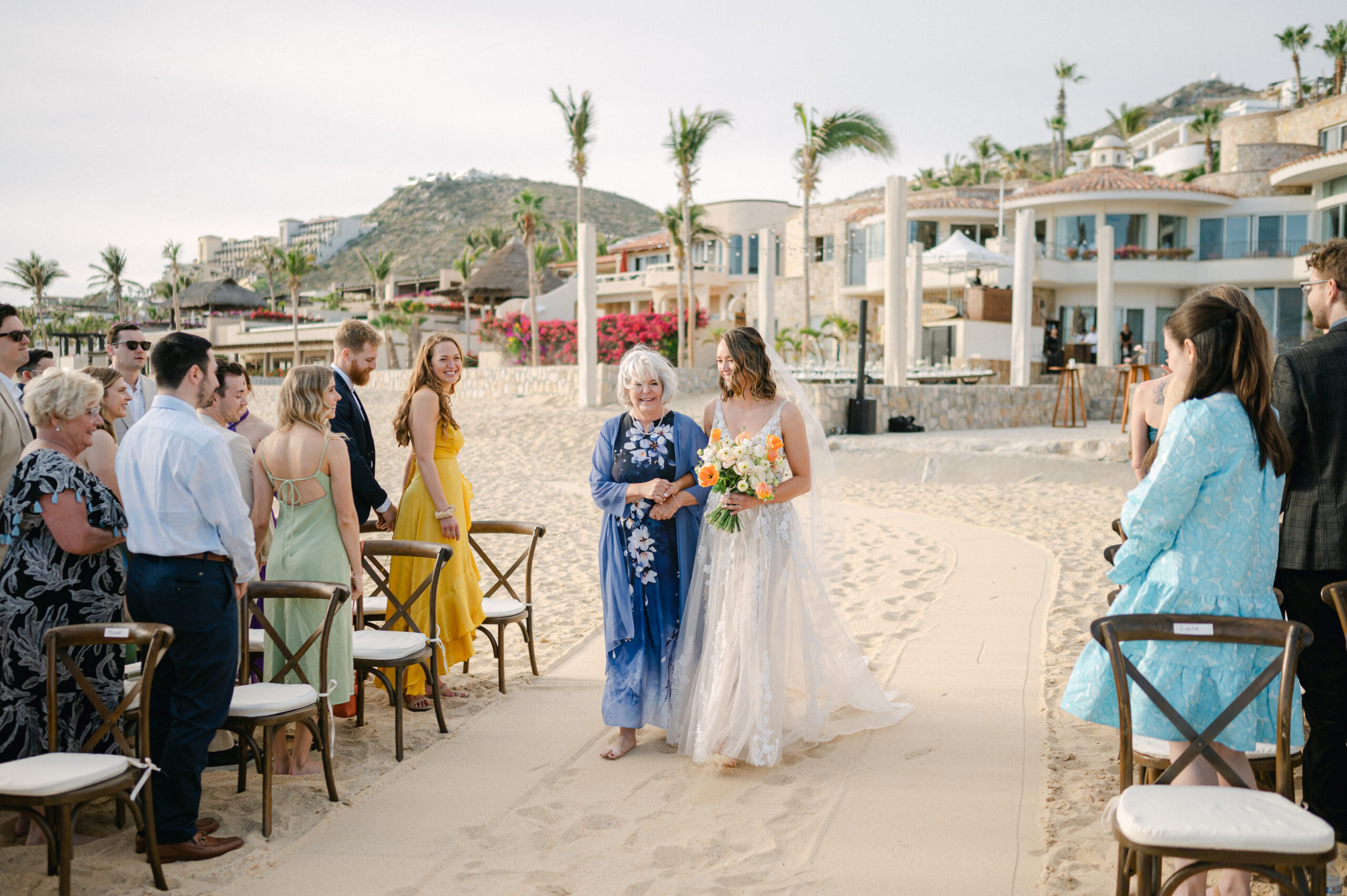 Bride walking down the sand aisle for her beach wedding ceremony in Cabo. 