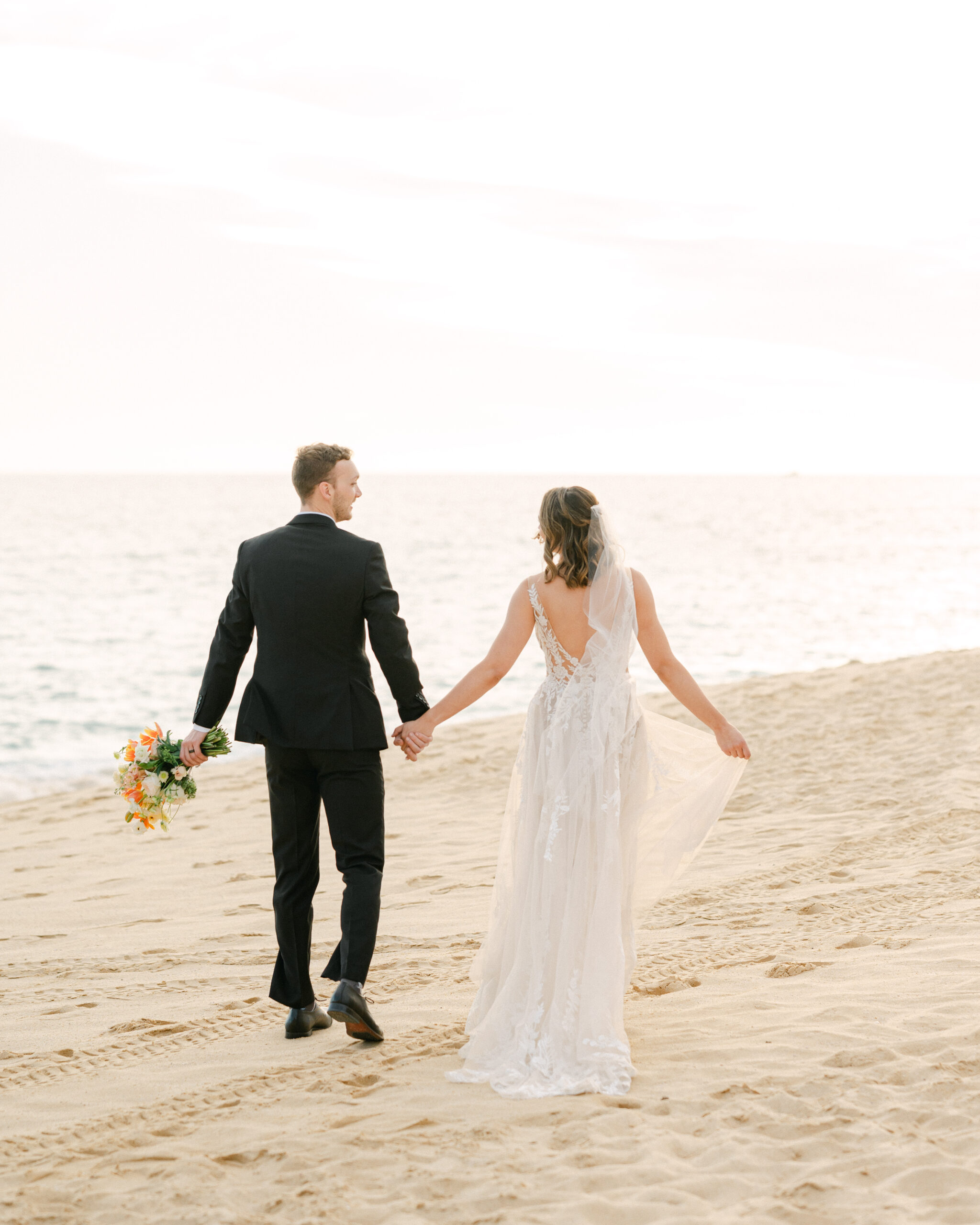 Romantic wedding weekend in Cabo bride and groom portrait on the beach at sunset. 