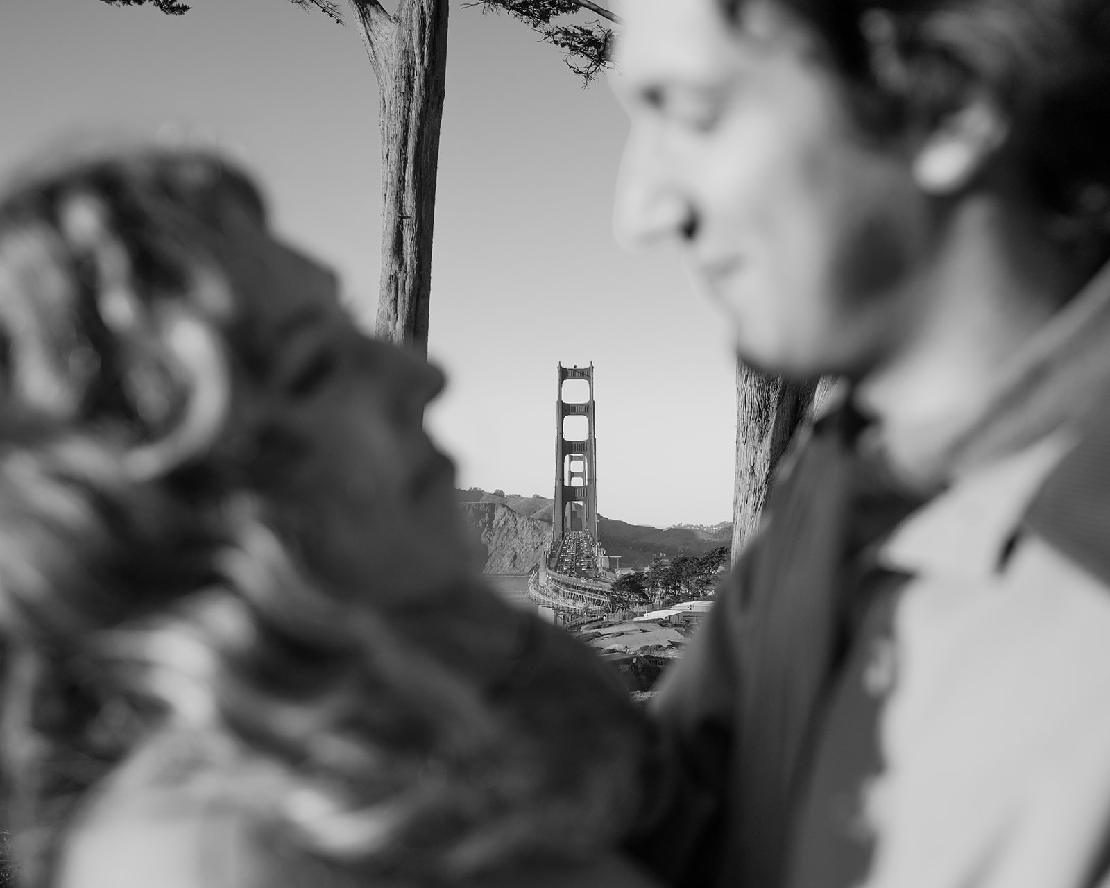 Documentary style engagement photo at the Golden Gate Bridge in San Francisco. 