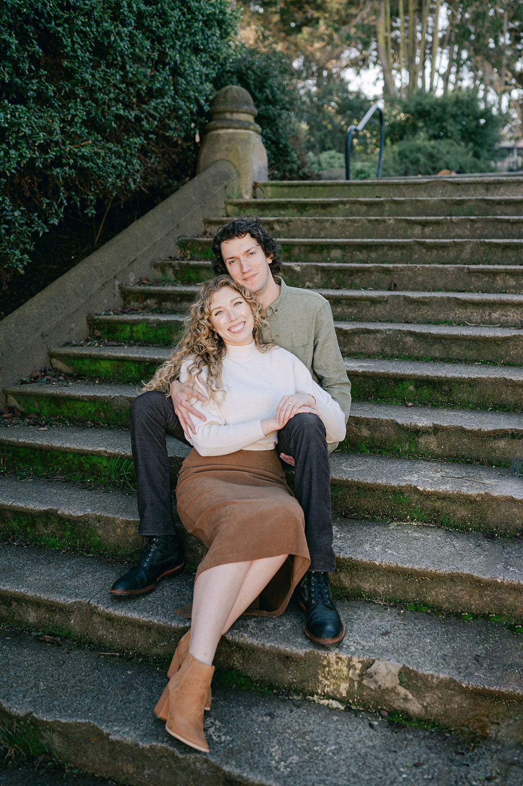 Couple posing on the stairs at Alamo Square for their San Francisco engagement session.