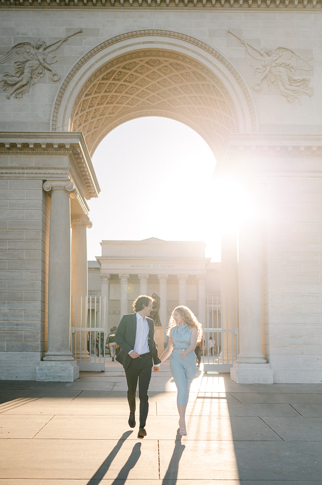 Candid couple running outside Legion of Honor in San Francisco for their engagement session.