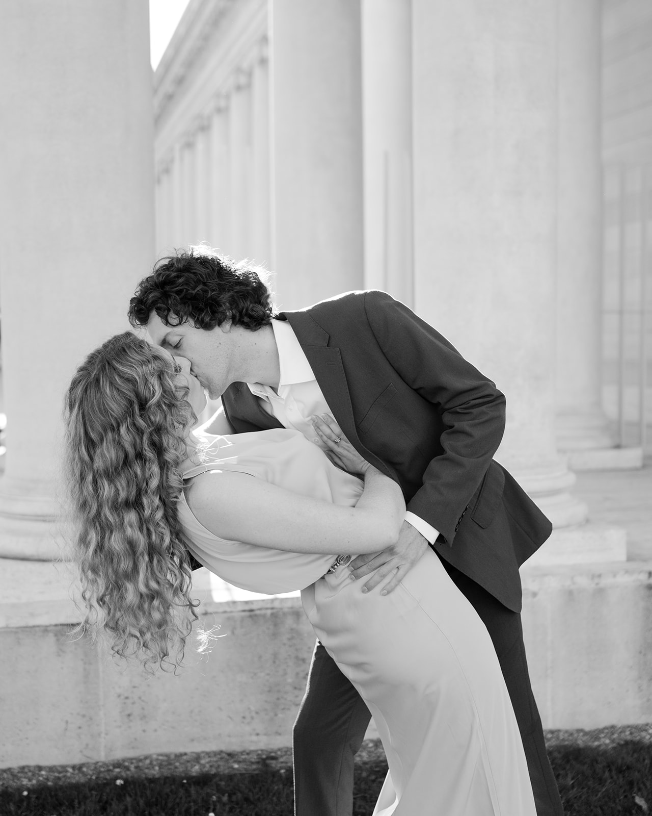 Black and white couple kissing engagement photo at Legion of Honor.  