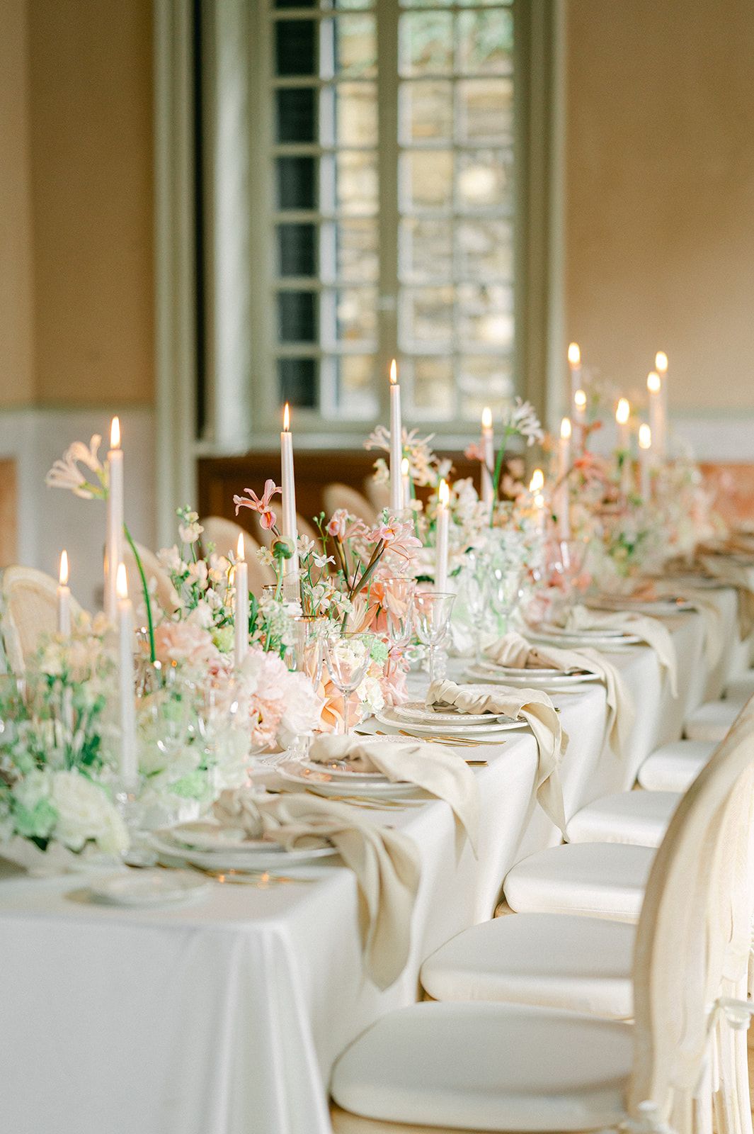 Modern and stylish wedding tablescape with candles, linens and greenery.