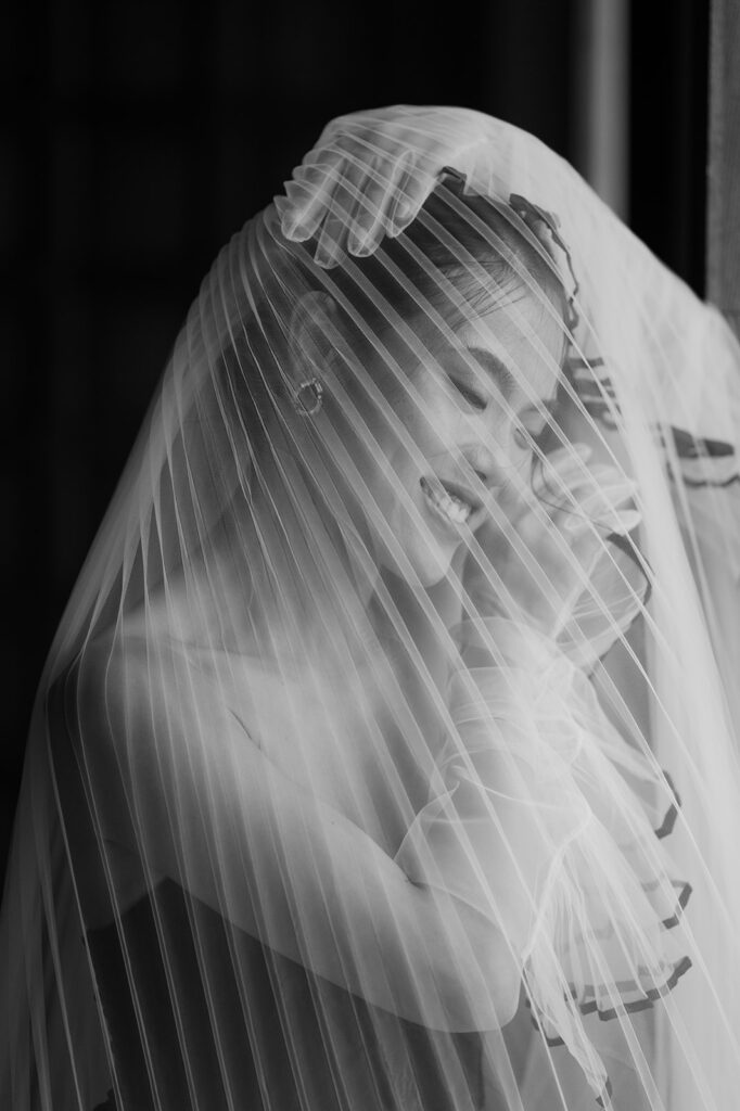 Fine art editorial bridal getting ready, under-the-veil shot. 