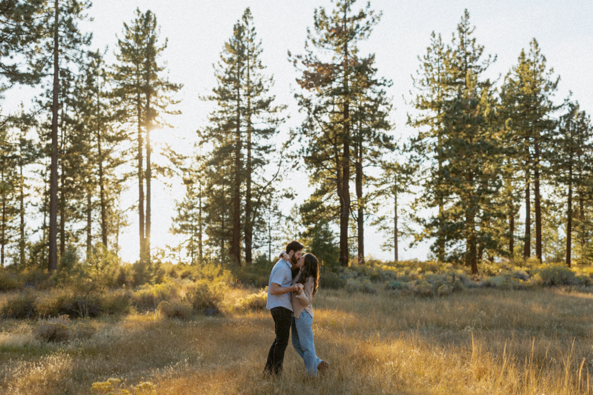 Man and Woman kiss during their engagement photos near Zeyphr Cove in Nevada. 
