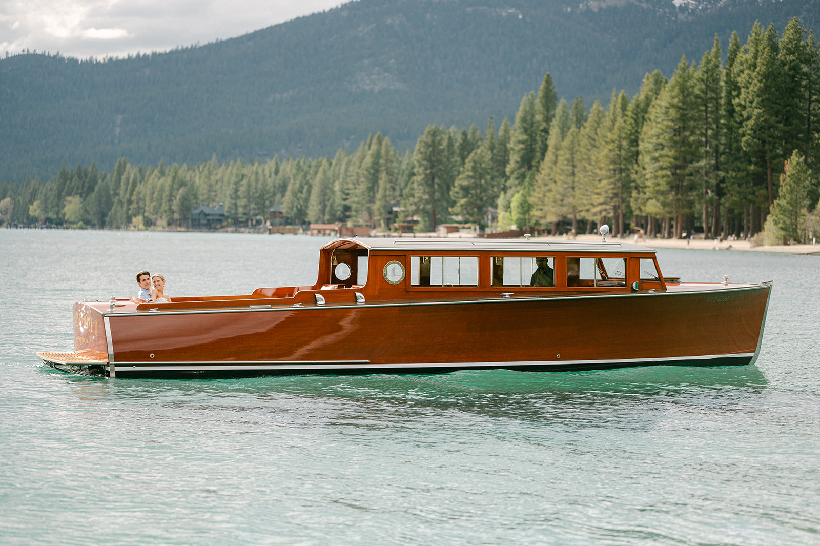 Couple enjoys wooden boat ride on the Wild Goose II on Lake Tahoe.
