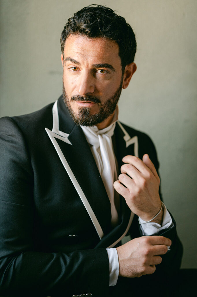 Italian destination wedding groom portrait featuring a custom monogrammed double-breasted black suit.