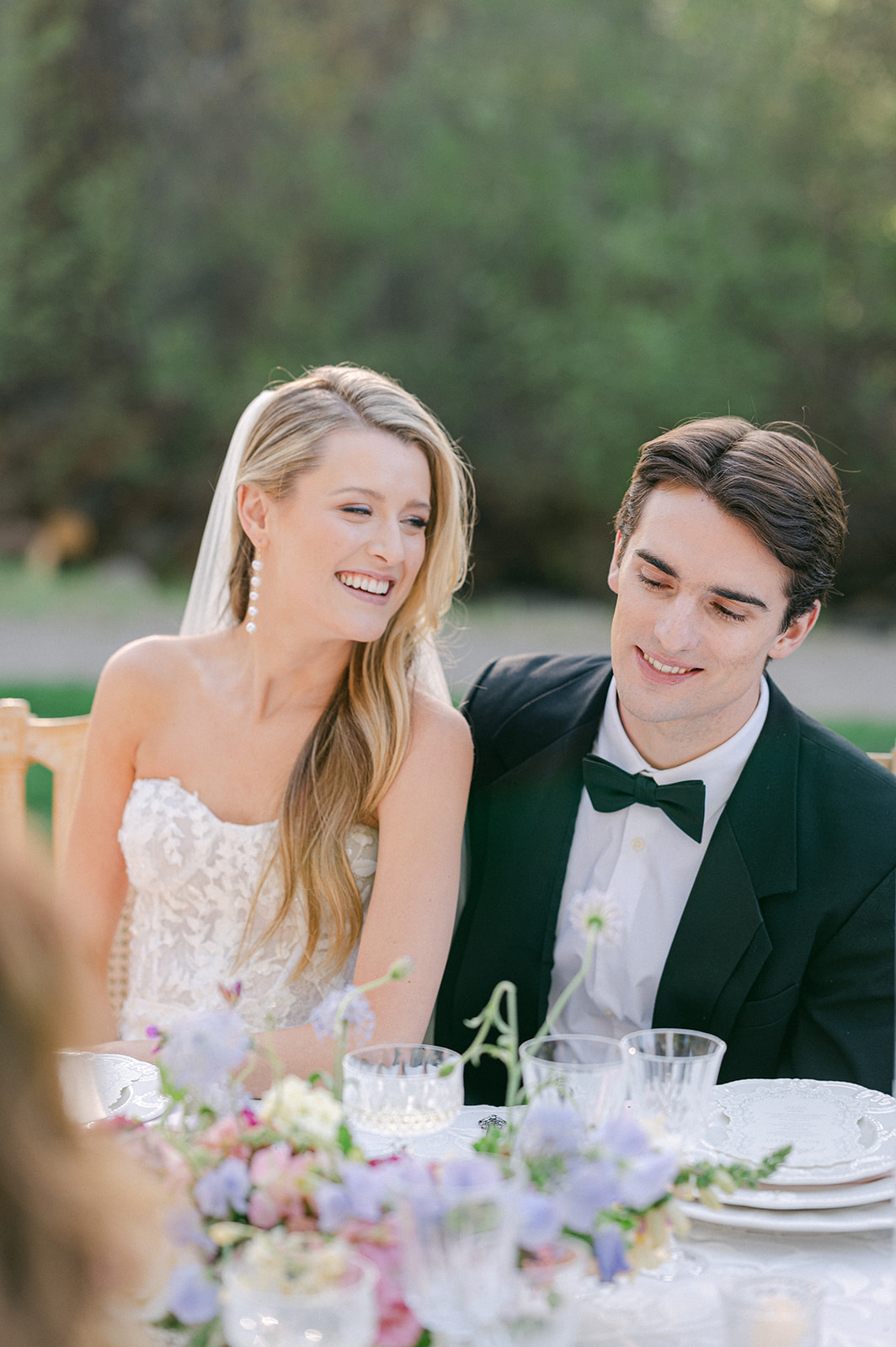 Bride and groom candid moment at their outdoor wedding reception dinner at the Hyatt Regency Lake Tahoe. 