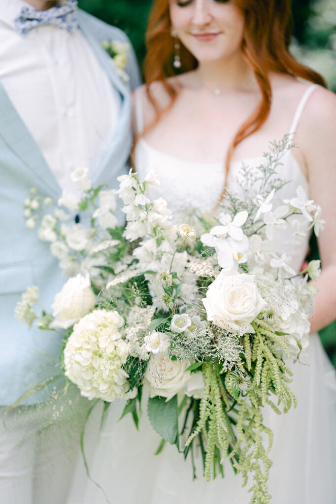 Beautiful couple portrait featuring the bride's white floral bouquet.