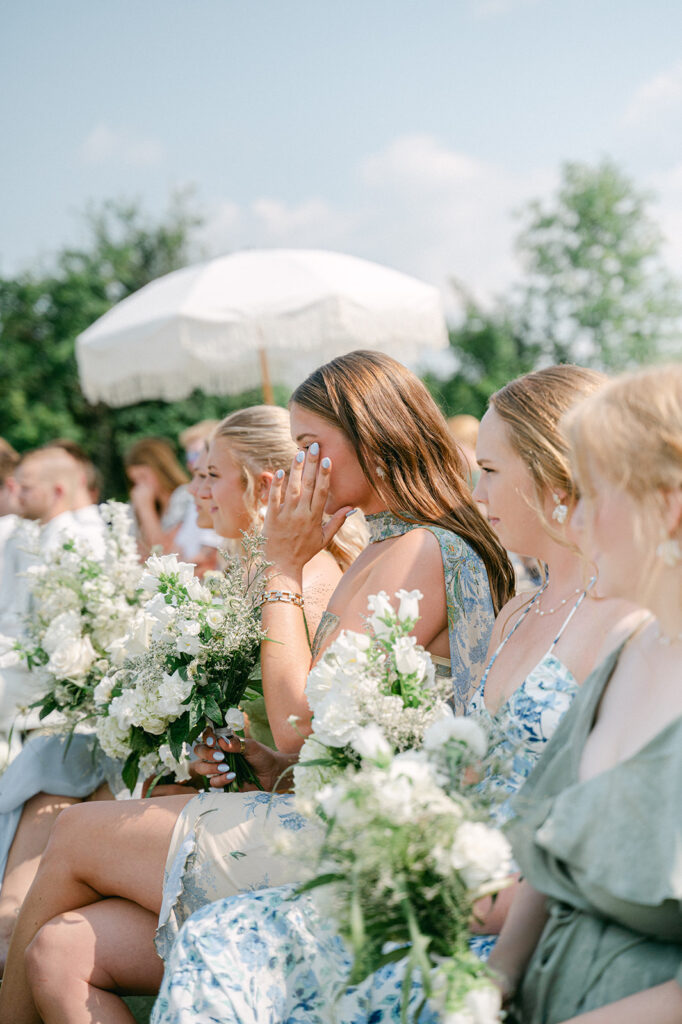 A documentary style portrait of bridesmaids getting emotional during the ceremony. 