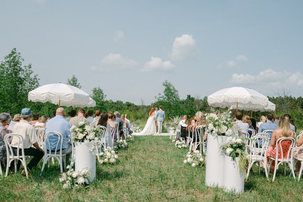 Whimsical white themed garden wedding ceremony in Battle Lake, MN. 