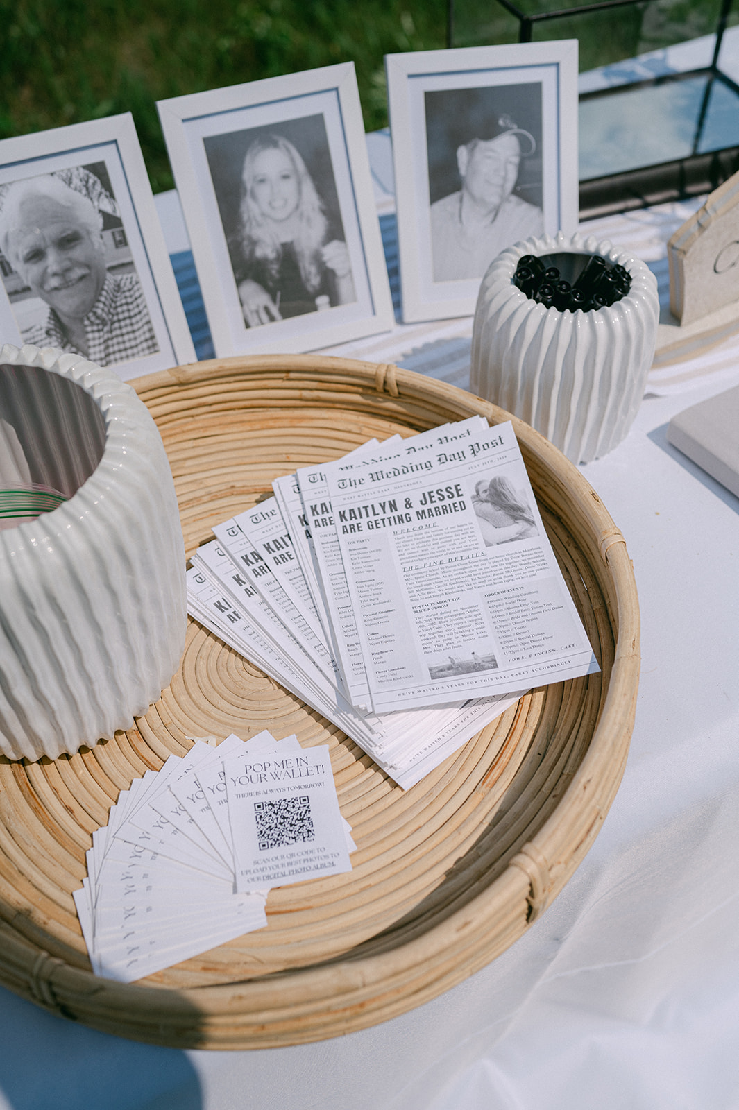 Wedding welcome table with newspaper programs and memory photos. 