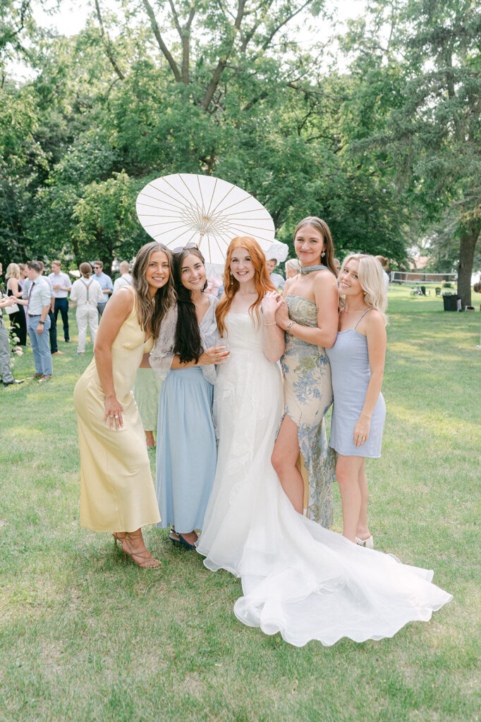 Bride and bridesmaid group portrait at cocktail hour. 