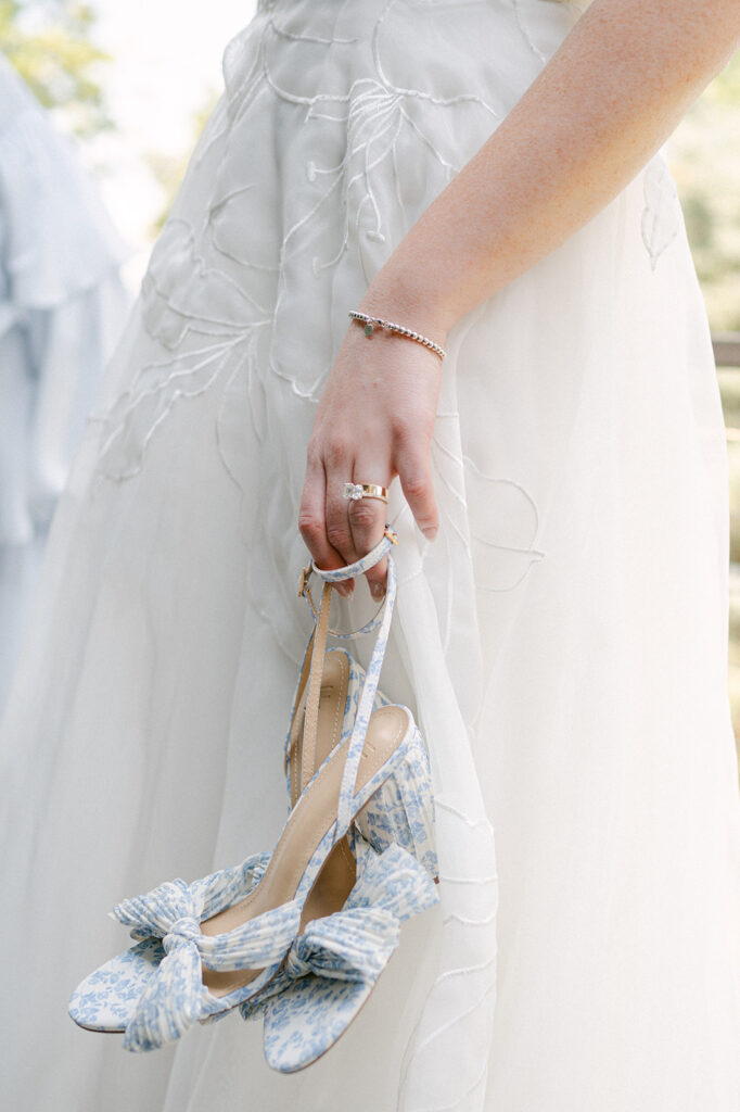 Close up detail shot of the bride's blue and white floral wedding heels. 