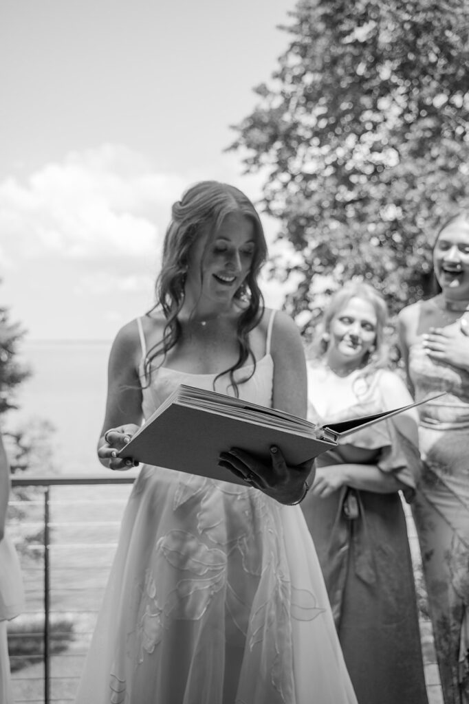 Candid moment of the bride getting emotional while looking through a photo book gifted by her bridesmaids