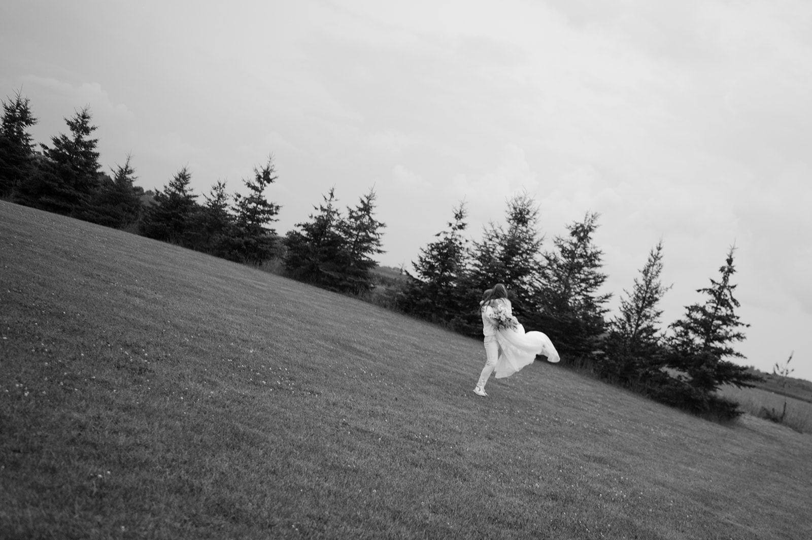 Cinematic motion-blur bride and groom portrait at their garden wedding in Battle Lake. 