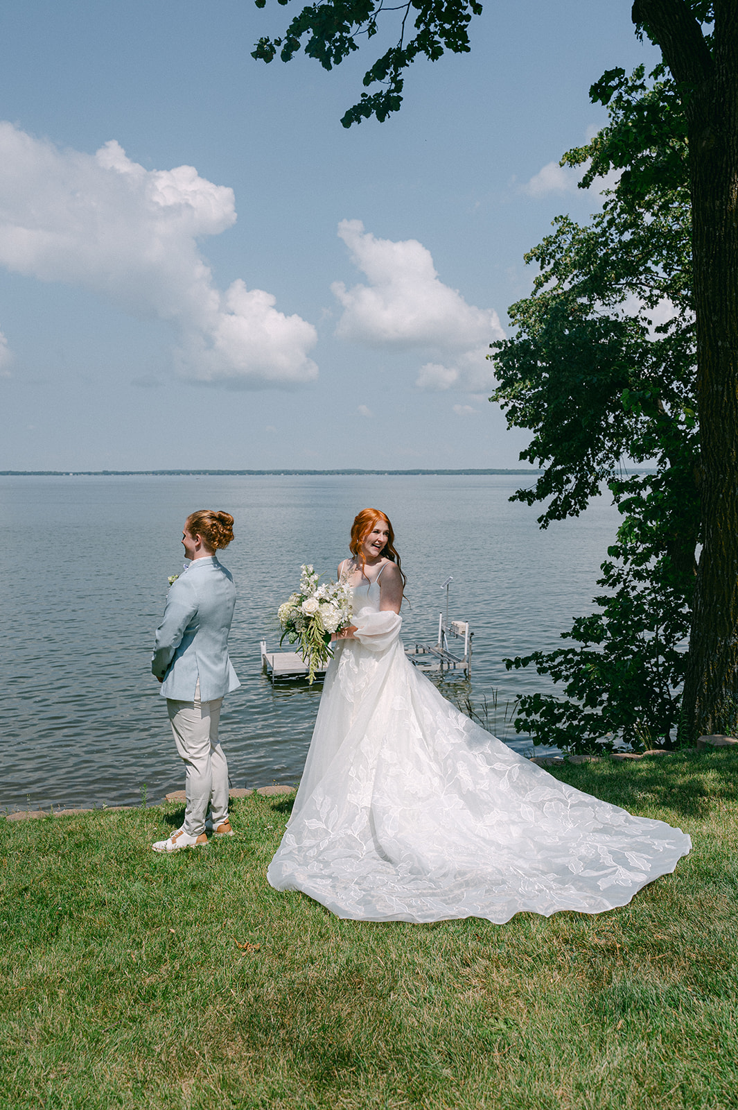 Emotional first look between the bride and groom with a stunning lake view. 