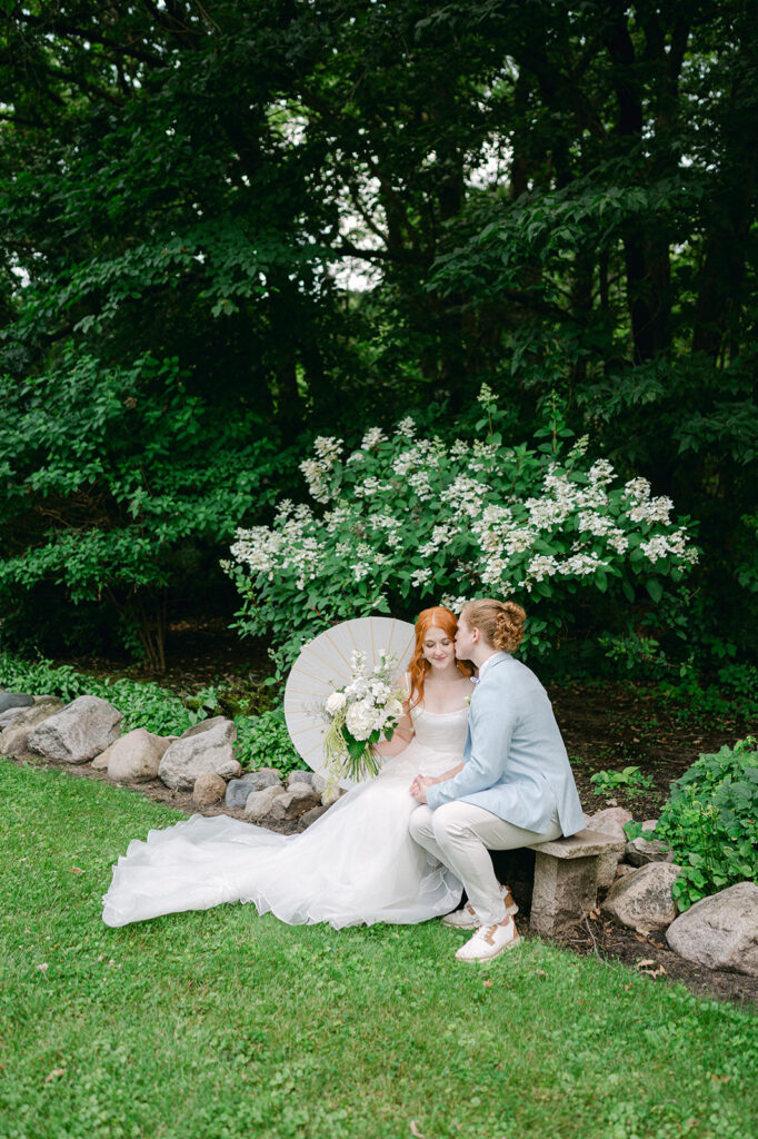 Candid portrait of the bride and groom embracing in the garden.