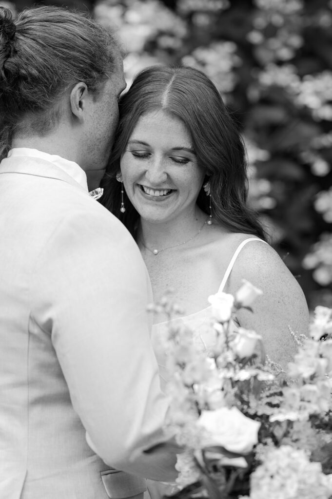 Fine art black and white portrait of the bride and groom in their garden party wedding.