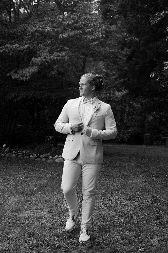 Black and white candid groom portrait.