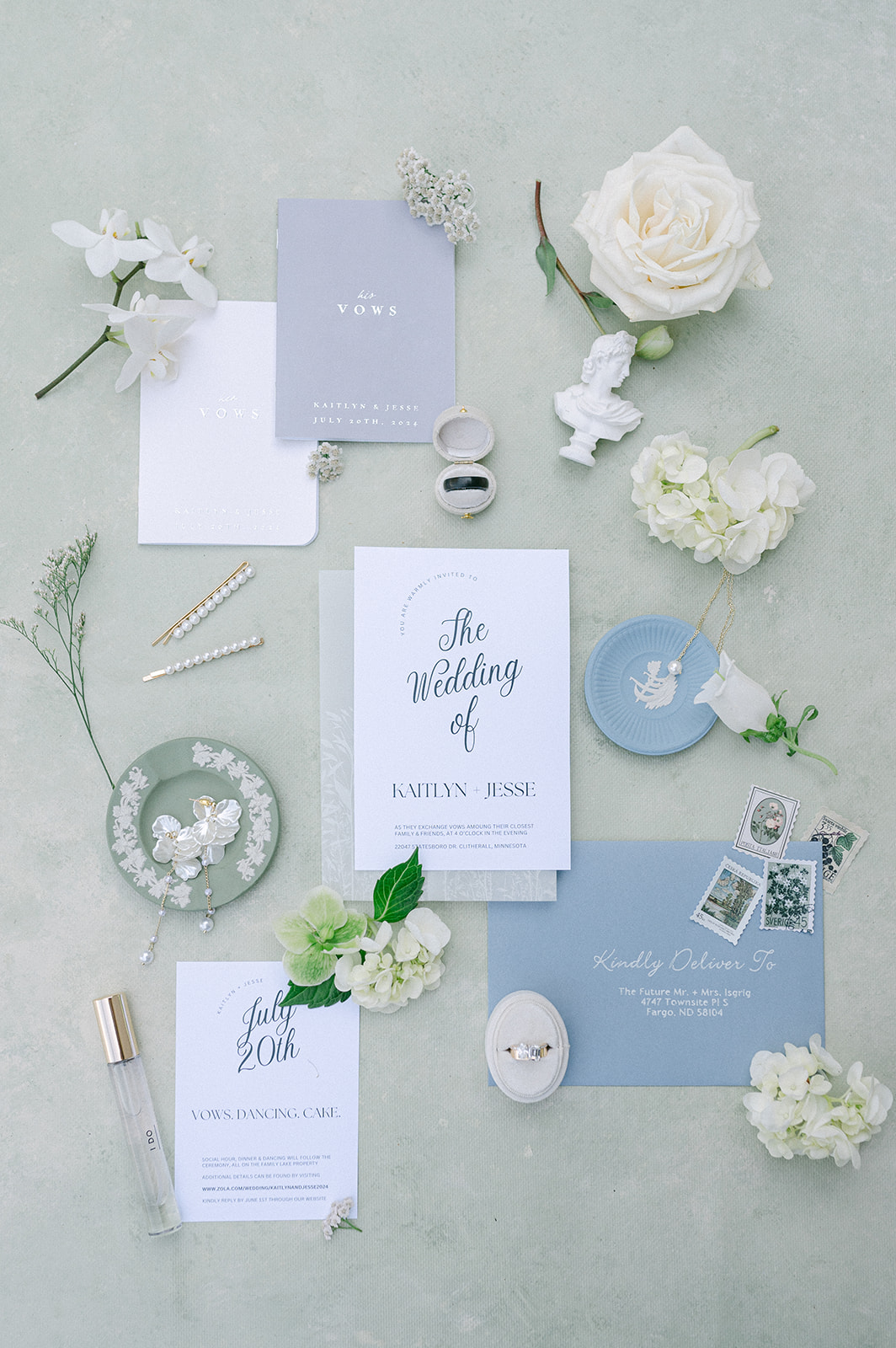 Blue and green garden party wedding detail flat lay with white flowers. 