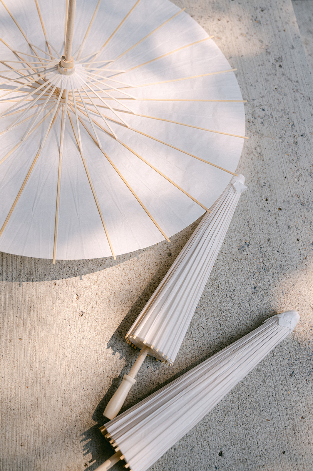 White paper parasol umbrellas for a fine art garden wedding in Minnesota. 