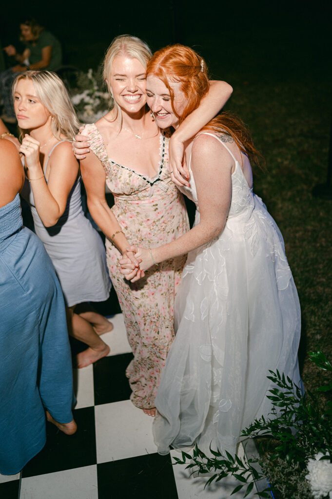 Candid bride and guest direct flash photo during the dance party. 