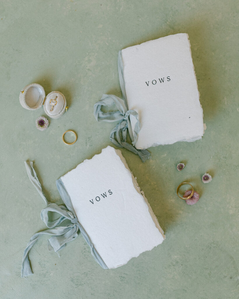 Wedding vow books and rings flat lay photography. 