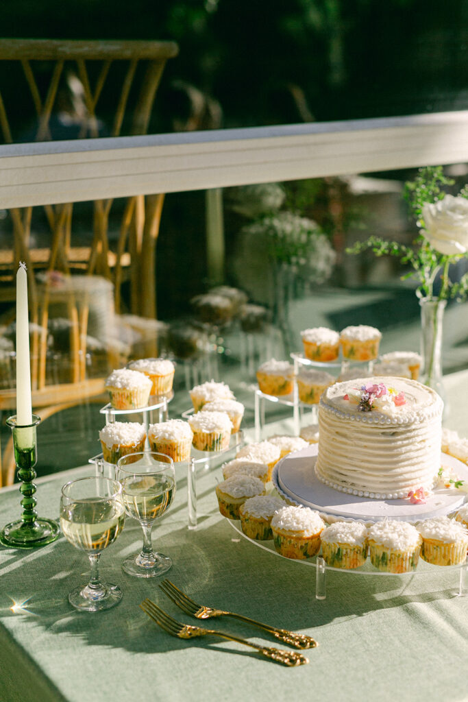 Garden wedding cake and cupcake table with gold flatware. 