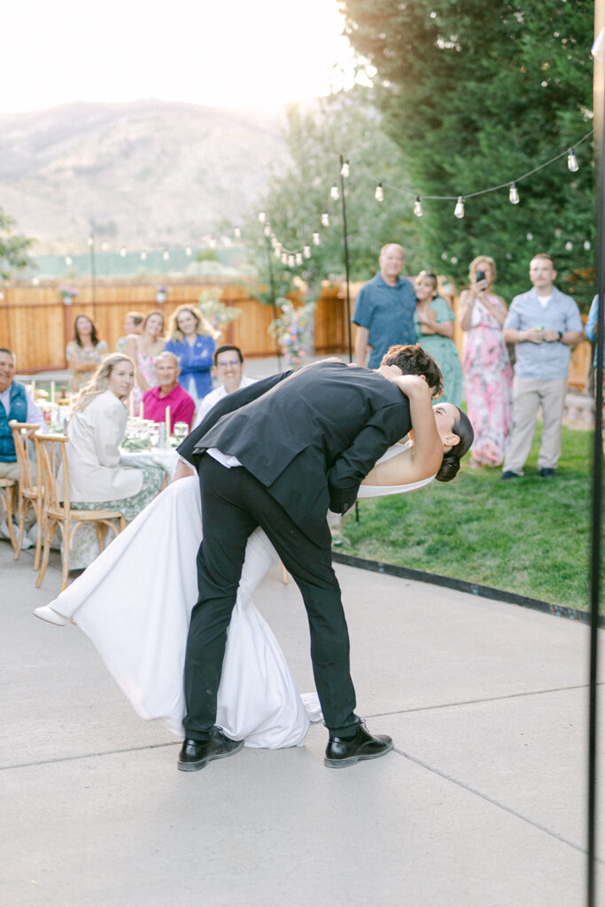 Bride and groom first dance kiss at their private backyard wedding in Lake Tahoe. 