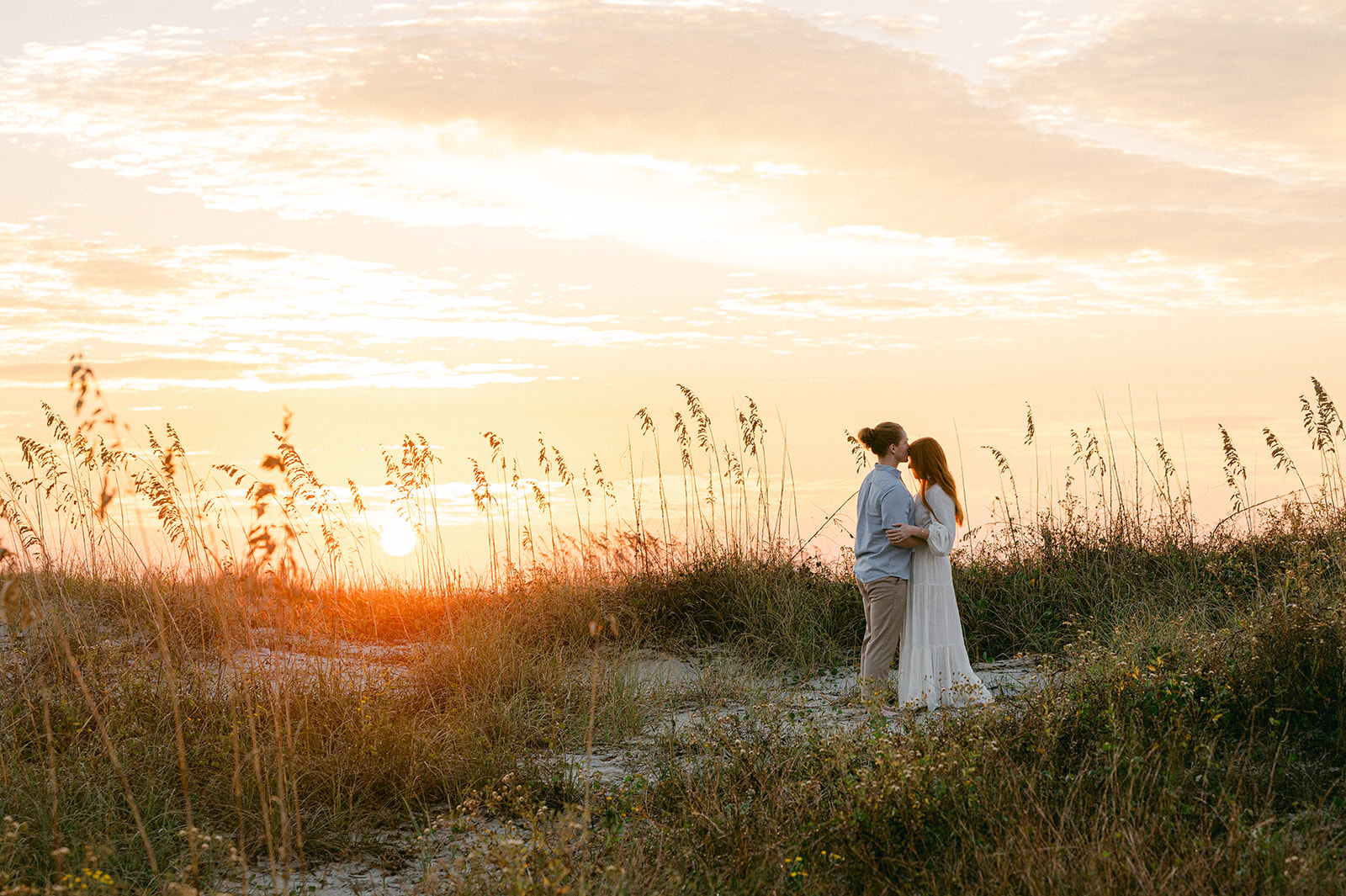 Sunrise engagement photo at Sullivan's Beach in Charleston. 