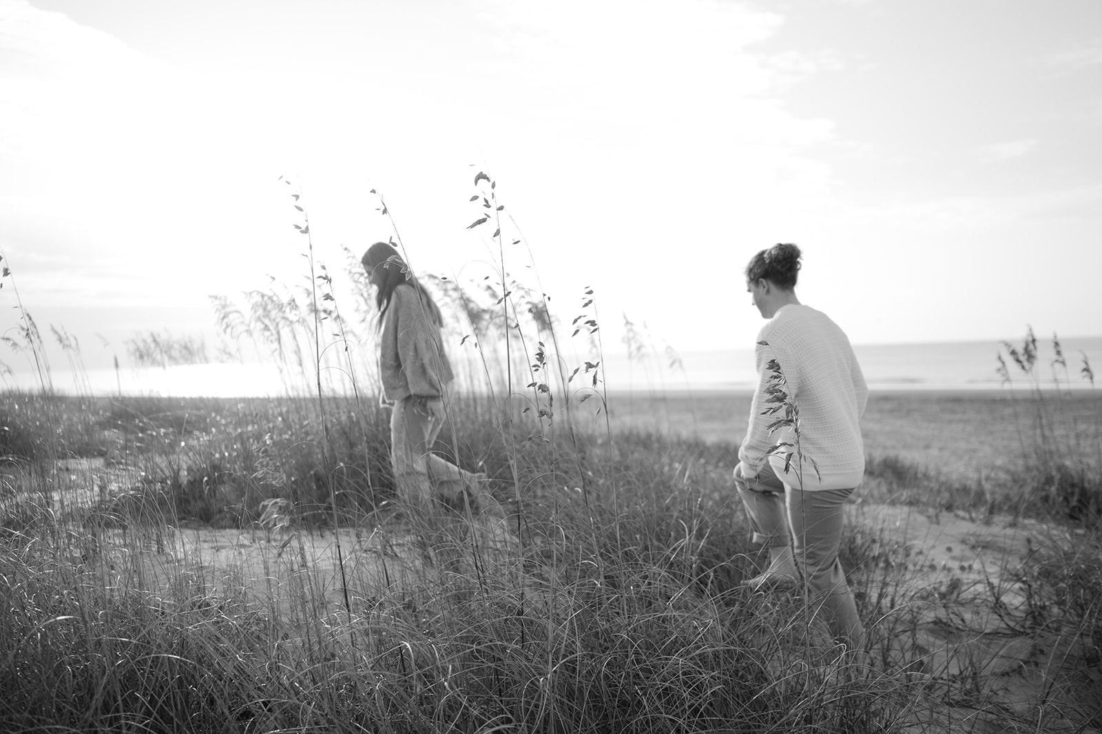 Documentary style beach engagement photo in Charleston. 