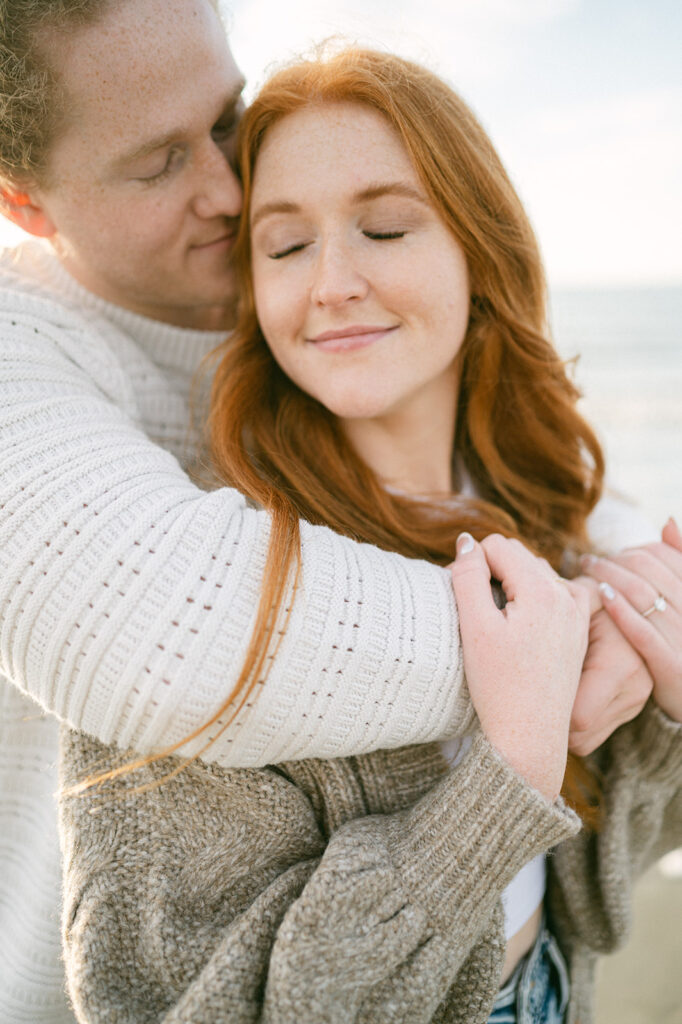 Husband hugs his wife during their engagement photos.